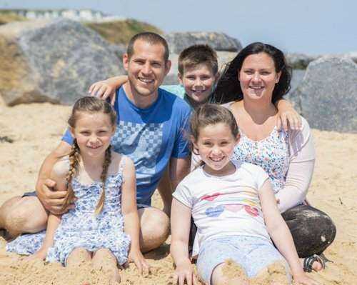 Family posing for a photograph at the Beach